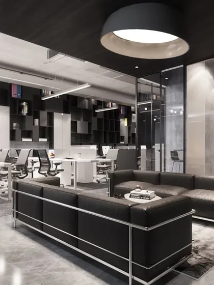The design for the AU Real Estate office uses a transparent aesthetic with glass walls and an open layout. This approach fosters a progressive work culture and creates a visually connected, modern workspace with defined zones for collaboration and individual tasks.