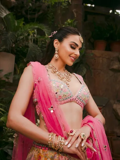 This shot captures the joyful essence of a mehendi look, complete with beautiful jewelry and a radiant smile.