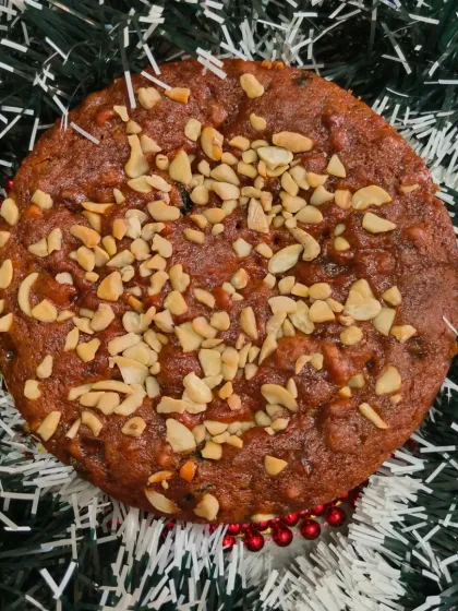My eggless rich fruit cake is dense, moist, and full of flavor. This version is topped with plenty of cashews for a nice crunch. It's a perfect homemade Christmas plum cake for your family.