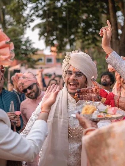 The joy and excitement are palpable as the groom is greeted by his family and friends.