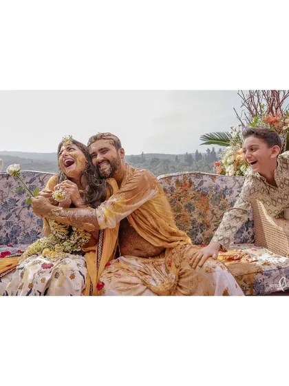 A hug after a very messy haldi. Sanjana and Maahir are covered in turmeric but all smiles, showing that they are in it together, no matter how chaotic it gets.