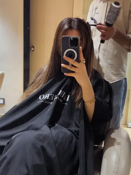 A behind the scenes shot of a client getting her hair styled after a color service. This shows the care and attention we put into every step.