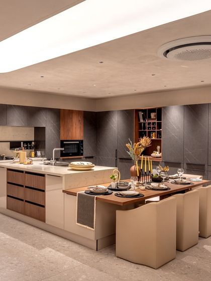 A stunning island display in our Delhi showroom that includes an integrated dining table, demonstrating how we can create multi-functional spaces for modern living.