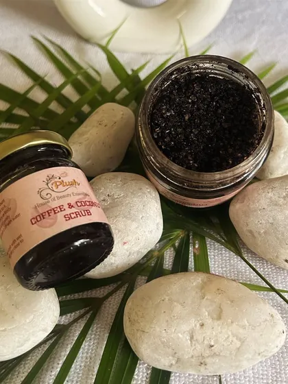 An open jar of my coffee scrub, showing its granular texture. It's perfect for scrubbing away dead skin cells and revealing a brighter complexion.