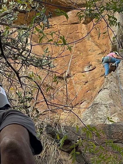 A belayer's perspective of a climber on a challenging route at Talai Betta.
