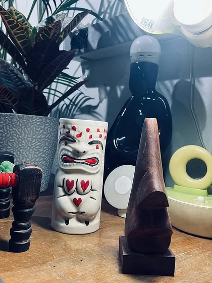 I believe your green space should show your personality. That's why I also find unique decor items, like this quirky tiki mug planter and wooden sculpture, to sit alongside your plants like this Croton.