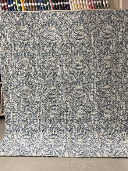 The back of the quilt, showing a subtle print that complements the front.