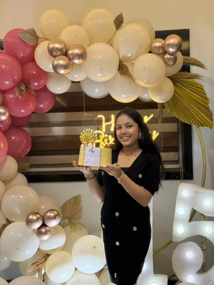 The birthday girl posing with her custom 15th birthday calendar cake.