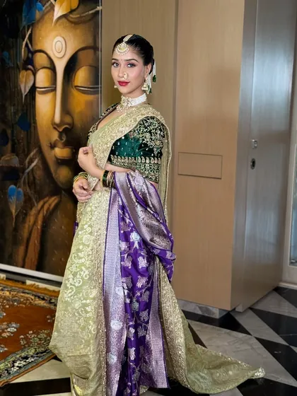 A full-length portrait showcasing the stunning Nauvari saree and the complete Maharashtrian bridal look. The makeup is designed to be both traditional and striking, fit for a queen.