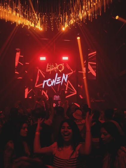 A partygoer loving the vibe right in front of the console at SinQ Nightclub. It's all about creating those individual moments of joy.