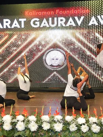 A creative and beautiful group formation combining backbends and balancing poses, designed to create a memorable visual for the audience.
