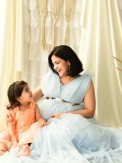 A quiet, candid moment between a mother and her daughter during a maternity shoot. This image captures the gentle conversation and bond they share as they await the new baby.