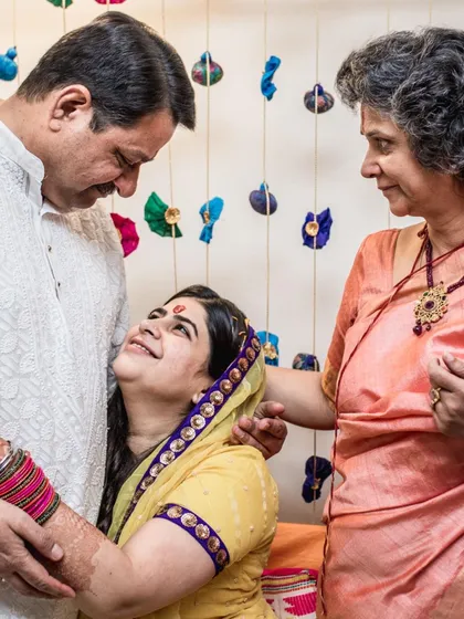A beautiful family moment, with the bride looking up at her father with so much love and admiration.