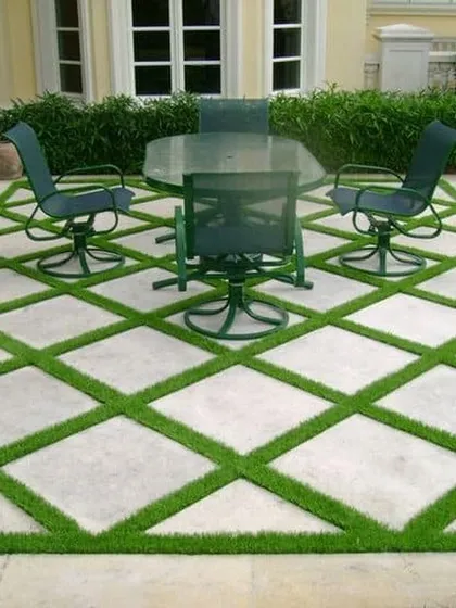 Your floor doesn't have to be boring. For this patio, I created a custom diamond pattern by integrating artificial grass with the existing stone tiles. This is a great example of how we can create a unique, high-end look for your outdoor space.