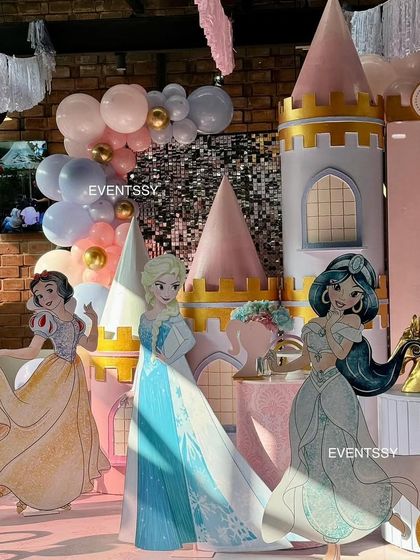 The full lineup of princesses, including Snow White, Elsa, and Jasmine, against the backdrop of a sequin wall and balloon garlands.