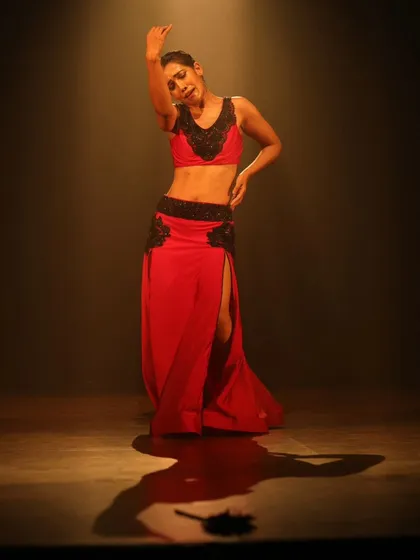 A solo performance still, capturing the light and emotion of being on stage.