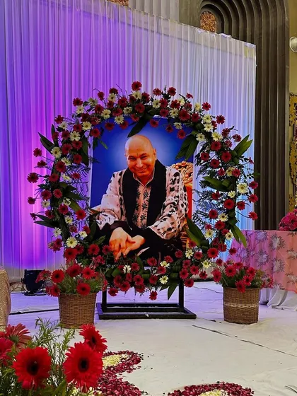 A close up of the floral wreath we created around Guru Ji's portrait. Using fresh red and white flowers, this arrangement becomes a beautiful focal point for the event's main stage.