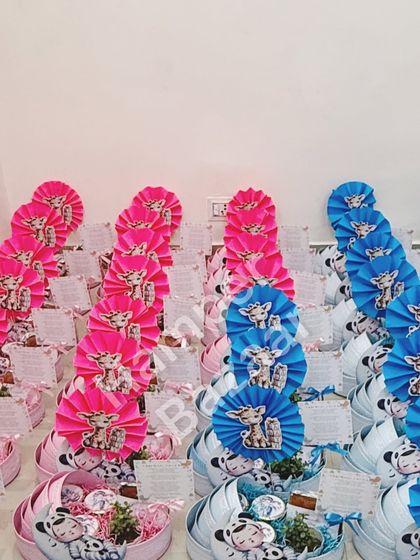 A view of a bulk order of our pink and blue pram hampers, ready for a baby shower or twin announcement.