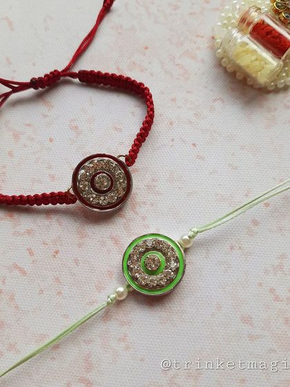 A pair of my sparkling crystal Rakhis in red and green. These are a great option if you want something that feels traditional but has a modern, festive shine.