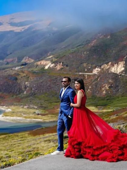 This couple looks so powerful and elegant against the stunning coastal cliffs in the US. The red ruffled gown adds a perfect touch of romance and drama to the scenery.