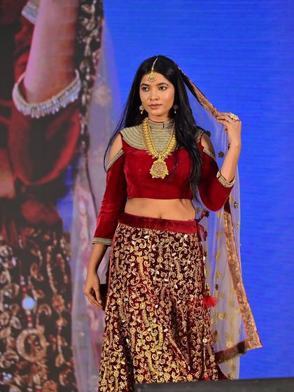 The beautiful actress Soumya Amarapurkar on the runway. I created a regal look with a bold red velvet lehenga and traditional gold jewelry.