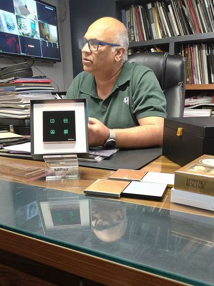 Architect Ashfaq Mukadam with our smart keypad at his desk, surrounded by design books. We are honored to be considered by such an esteemed professional.