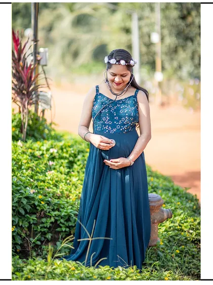 A sweet solo shot in a garden, with the mom-to-be using a stethoscope on her belly.