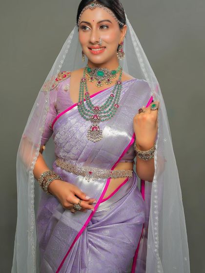 Where lavender grace meets diamond dazzle. Dr. Shruthi looks like royalty in this lavender Kanchipuram silk saree with a sheer veil.