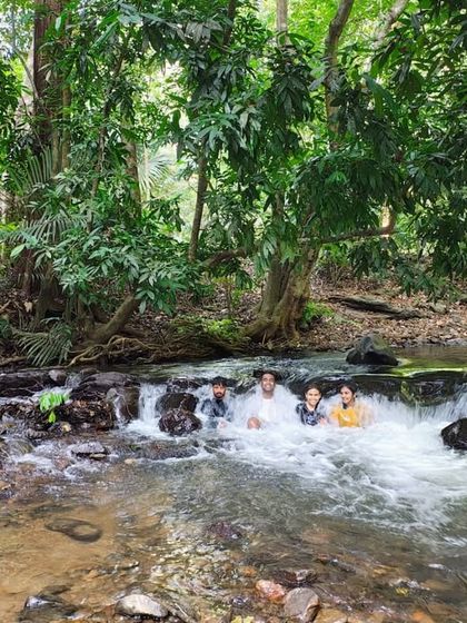 A group enjoying a cool dip in a forest stream. It's the best way to beat the heat.