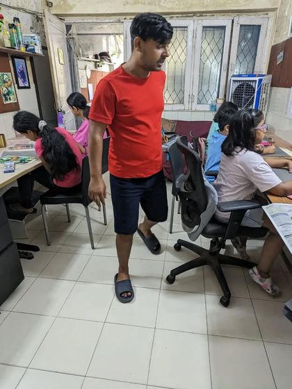 A candid shot of our instructor walking through the classroom, checking on students' progress and offering encouragement.