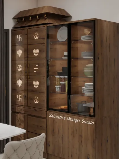 A closer look at the custom-designed pooja and crockery unit, detailing the wooden finish and the sacred symbols (Om, Swastika, Lotus) carved into the doors.