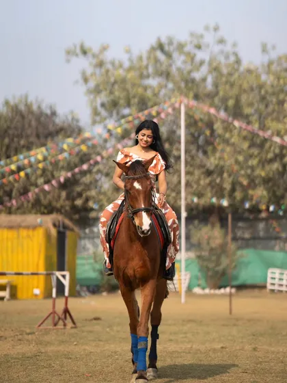A rider enjoying a gentle trot, with our colorful event flags in the background.