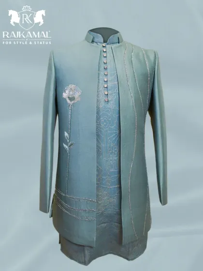 A sophisticated pastel green Indo-Western outfit. This piece features delicate silver embroidery, including a single rose motif, and an elegantly draped asymmetrical design.