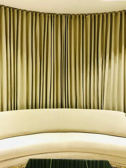This custom curved sofa was designed to fit perfectly against the rounded wall, demonstrating how bespoke furniture can solve unique architectural challenges in a home.