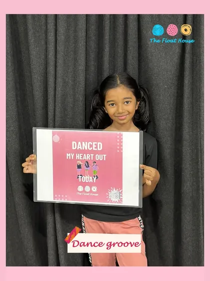A young dancer proudly showing off her achievement after a session. We love being a space where kids can find their rhythm and build confidence.