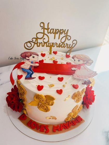A classic white and red ribbon-pull anniversary cake.