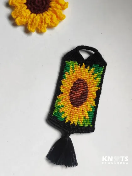 Another shot of the hand-knotted sunflower keychain, next to a crochet sunflower for a sunny comparison.