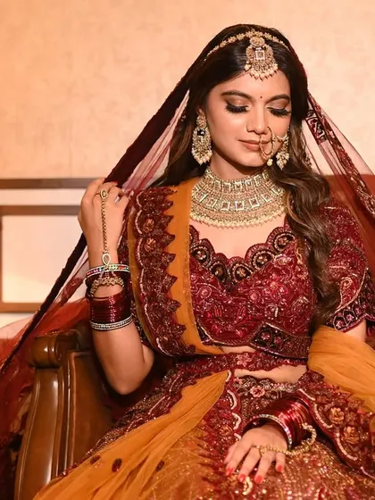 A full portrait showcasing the entire bridal look, from the maang tikka to the flowing dupatta. This type of shot is essential for lookbooks and catalogues, giving a complete view of the outfit.