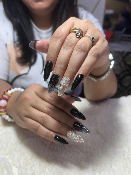 A glamorous black stiletto set with full-coverage crystal accent nails. I teach the proper technique for applying rhinestones so they last.