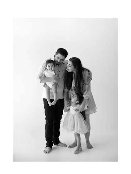 This is what it's all about. A quiet moment in my studio with nothing but family, love, and simple, honest connection. This black and white family portrait captures the tenderness between parents and their little ones.