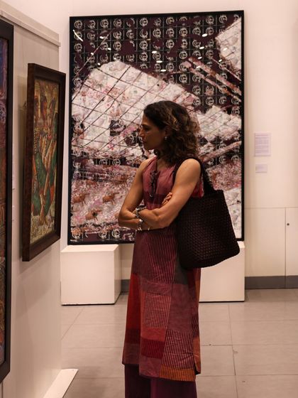 A visitor contemplates the layered digital art of Avinash Veeraraghavan, capturing a moment of deep engagement during our exhibition.