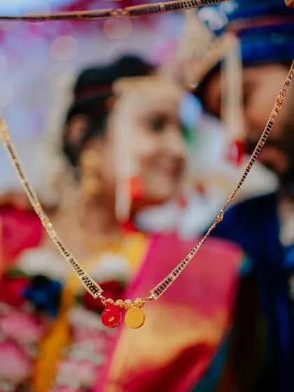 A symbolic shot focusing on the Mangalsutra, a centerpiece of the Maharashtrian wedding ceremony. Capturing these crucial details is essential to telling the complete story of your union.