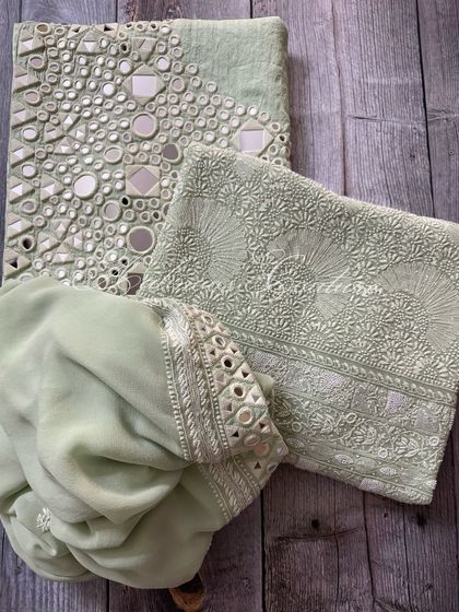 A flat-lay of the complete mint green set, including the kurta, palazzo, and dupatta.