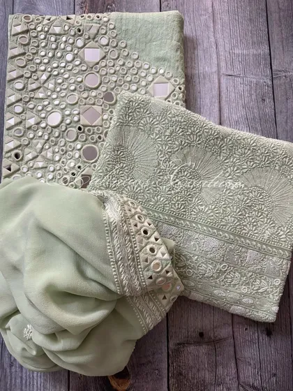 A flat-lay of the complete mint green set, including the kurta, palazzo, and dupatta.