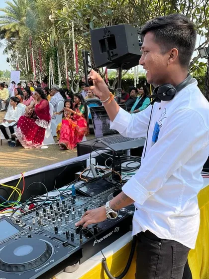 Interacting with the crowd while DJing at an outdoor function.