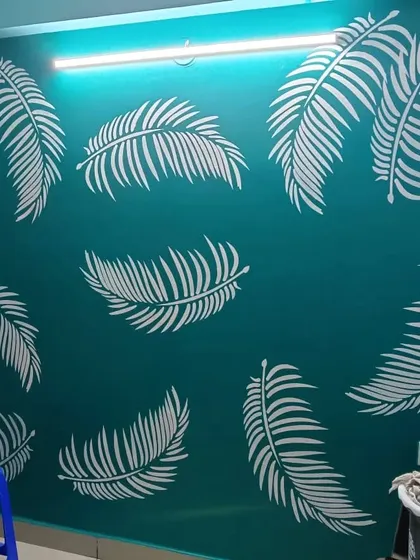 A vibrant teal wall brought to life with a scattered pattern of crisp white palm leaf stencils, creating a fresh, tropical-inspired accent for any room.
