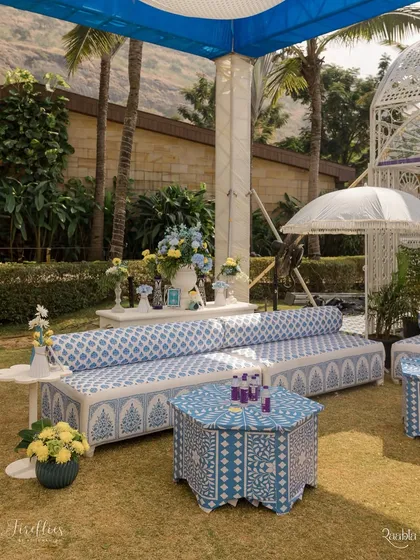 A chic lounge area with custom-printed sofas and bone-inlay style tables. The blue and white patterns were inspired by Jodhpur's aesthetic, creating a sophisticated yet festive vibe.