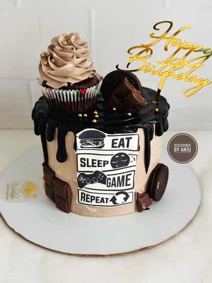 "Eat, Sleep, Game, Repeat." A fun cake for a gamer, featuring a chocolate drip, Oreos, and a gaming-themed topper.