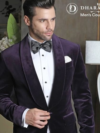 A close-up of a luxurious deep purple velvet tuxedo jacket. The shawl collar and rich texture make it a sophisticated choice for any evening event.