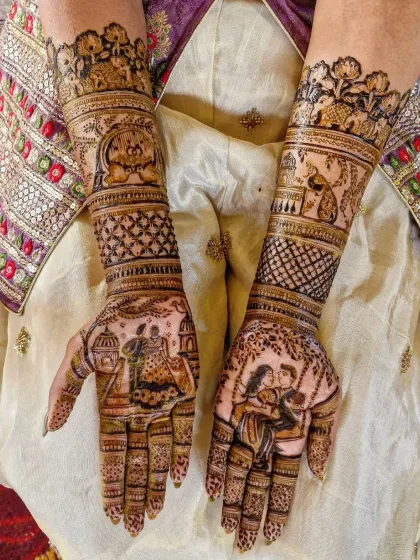 This engagement mehendi tells a complete love story. It includes a portrait of the couple on a swing, a varmala scene, and symbols of their journey together.